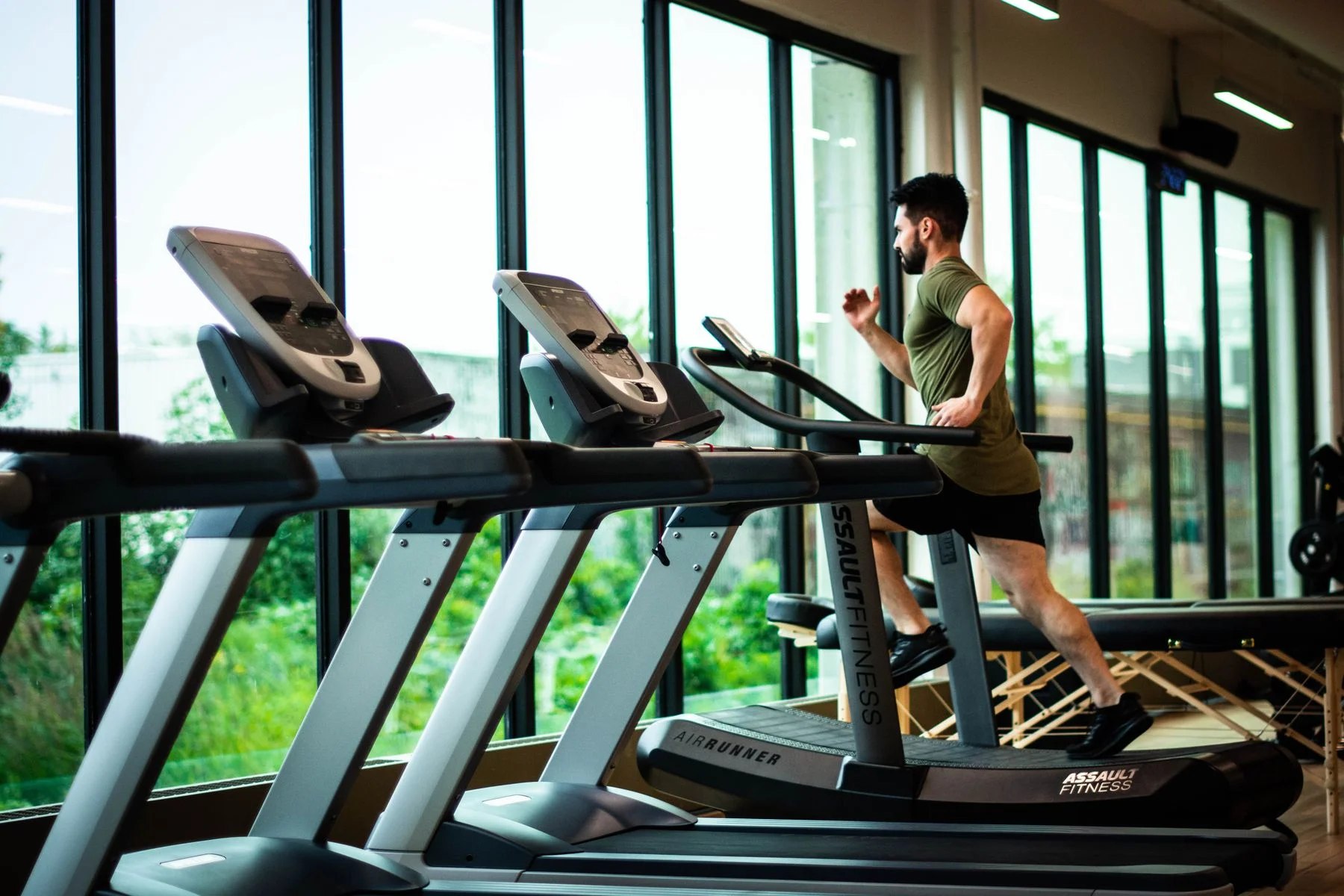 A bright gym floor with treadmills