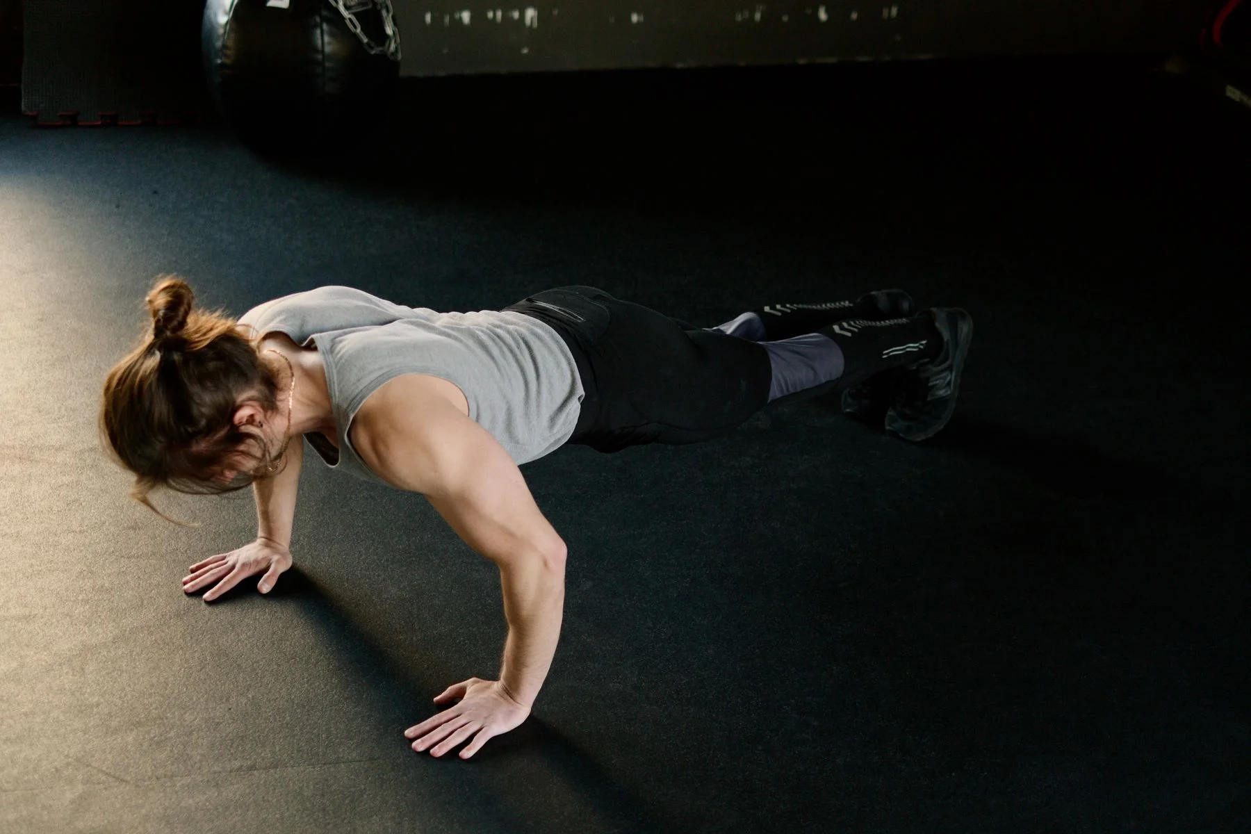 A person doing a floor exercise in a gym