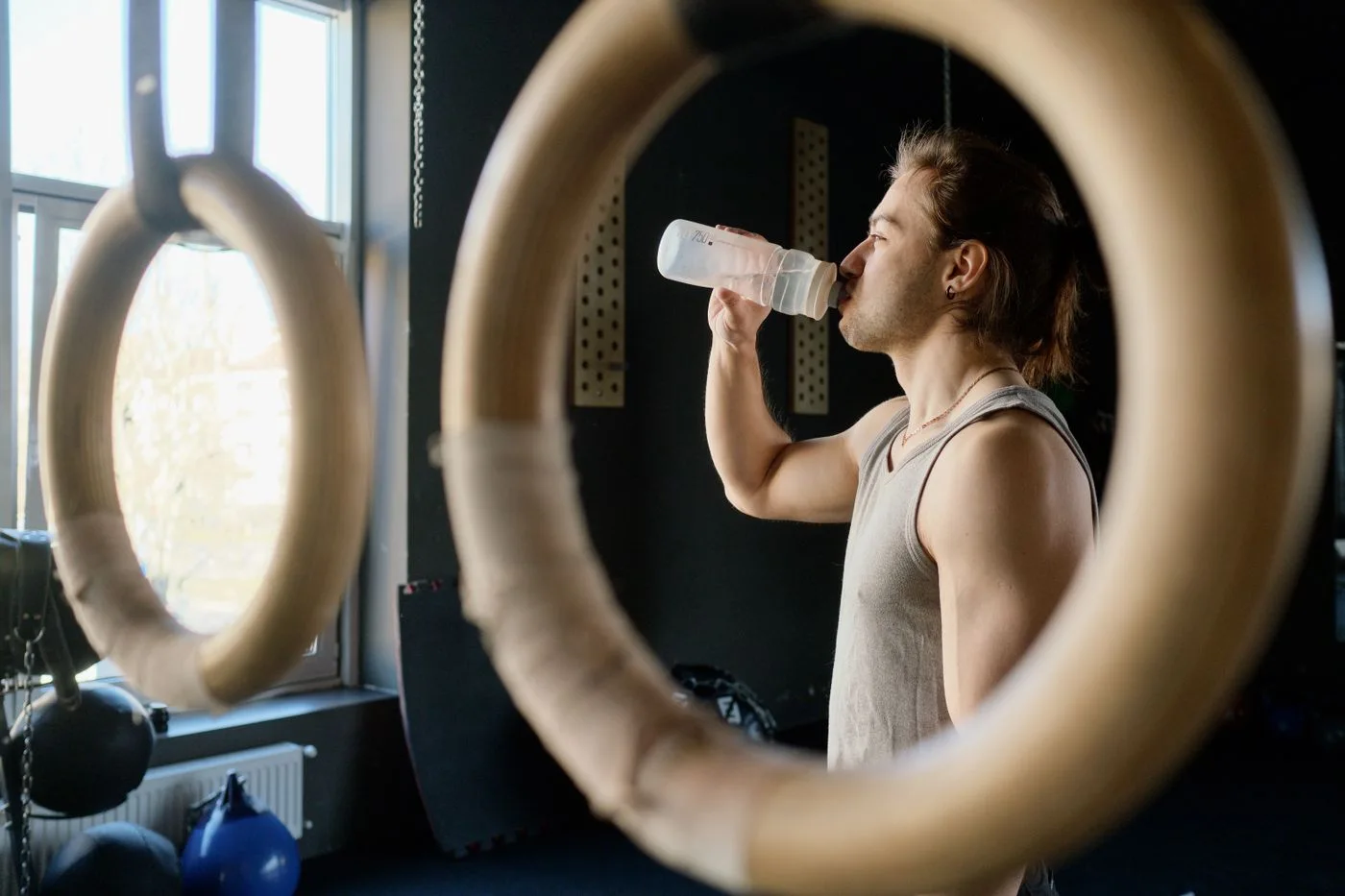 A person taking a water break between exercises